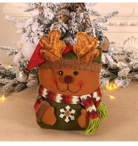 Detailed close-up of a festive plush reindeer Christmas gift bag with knitted scarf decor