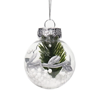 Clear Christmas ornament with artificial pine, silver ribbon, and decorative snow balls
