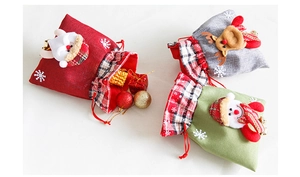 Detail of Christmas burlap drawstring gift bags with Santa and reindeer appliques