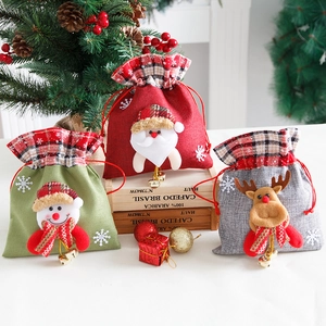 Three linen Christmas gift bags with 3D Santa, Snowman and Reindeer designs for holiday decor