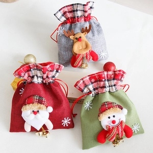 Three Christmas burlap drawstring gift bags with Santa Snowman and Reindeer cartoon designs
