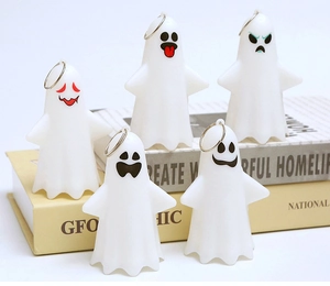 Close-up of five Halloween ghost LED hanging lamps with unique expressions on books