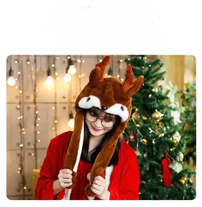 Brown plush reindeer hat with moving ears and 3D antlers in festive Christmas setting