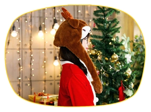 Detail of plush reindeer earflap hat with 3D antlers in warm Christmas home setting