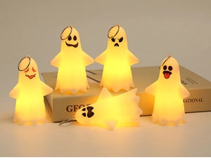 Close-up of five ghost LED candle keychains with different facial expressions and warm light
