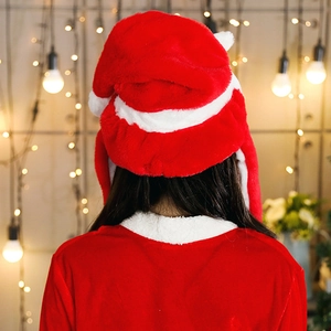 Detail of plush Christmas hat with ear protection and matching velvet festive outfit