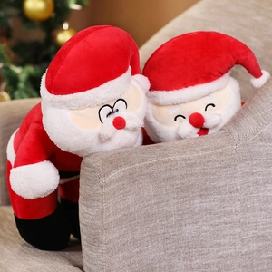 Detail view of red plush Santa Claus hats featuring two different cute facial expressions