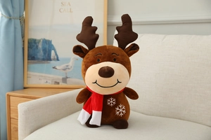 Plush Christmas reindeer toy with a red scarf and snowflake embroidery on a cozy sofa