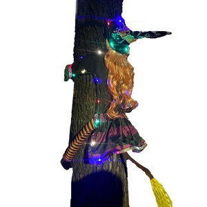 Halloween crashing tree witch decoration with orange hair and purple dress featuring LED lights