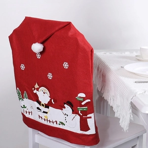 Christmas Santa hat chair covers with reindeer prints for festive holiday dining room decor