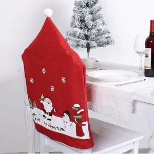 Festive red Santa hat chair covers with snowman print for Christmas dining room decor