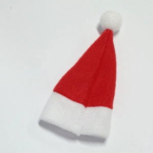 Close-up of mini red and white non-woven Christmas hats for lollipop decoration
