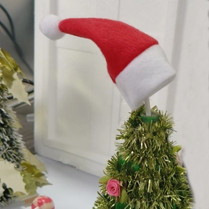 Close-up of mini red felt Christmas hat for lollipops and holiday ornaments
