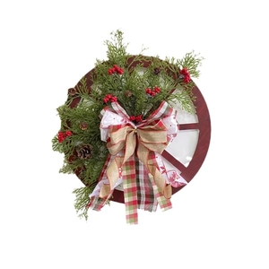 Festive Christmas wooden wheel wreath with pine cones berries and plaid bow decoration