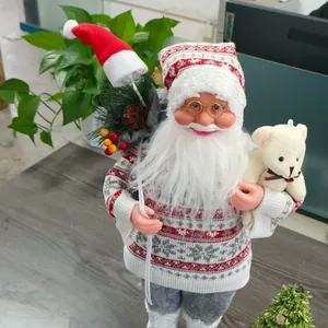 Close-up of Nordic Santa figurine with knit sweater, golden glasses and a plush bear