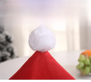 Close-up of red soft wool Christmas hat chair cover with white plush pompom detail
