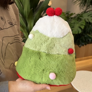 Detail of a Christmas tree plush doll with colorful pom-poms and soft faux fur texture