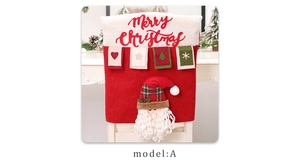 Detail of Santa Claus chair cover with 3D plush doll and Merry Christmas embroidery