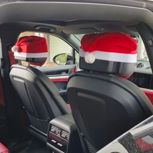 Detail view of red Christmas car headrest covers installed in luxury vehicle interior