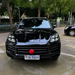 Close-up of brown plush reindeer antlers and red nose mounted on a black SUV car exterior