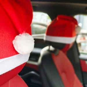 Christmas hat style car headrest covers in red velvet with plush white trim decorations