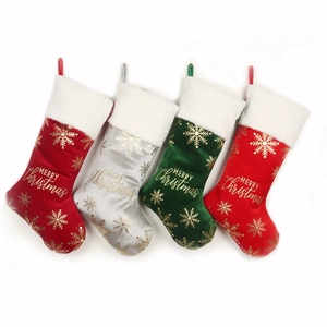 Four velvet Christmas stockings with gold snowflake patterns and white faux fur cuffs