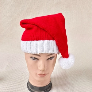 Classic red and white knitted Christmas hat with pompom on mannequin display