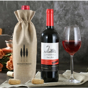 Detailed close-up of a rustic burlap wine gift bag with drawstring and tree logo
