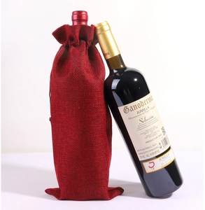 Detail of red burlap wine gift bags with drawstring closure for Christmas bottles