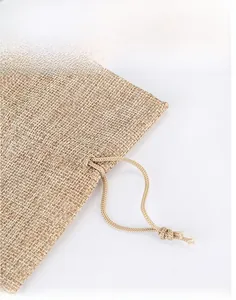 Detailed view of woven jute wine bag texture featuring a durable double drawstring closure