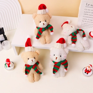 Mini plush Christmas bears wearing knitted red hats and striped scarves on a display shelf