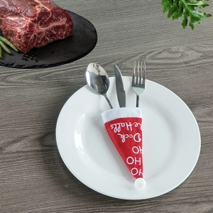 Christmas Santa hat cutlery set with festive embroidery on elegant white ceramic plate