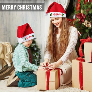 Detail view of red plush Santa hats in adult and kids sizes for festive family outfits
