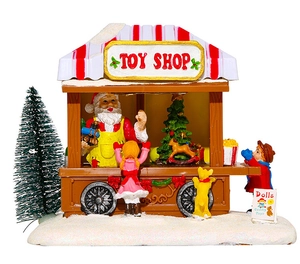 Dettaglio scena negozio di giocattoli natalizi con Babbo Natale e figure festive luci