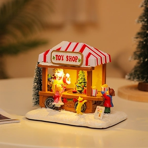 Casetta musicale natalizia illuminata con Babbo Natale e decorazioni di neve per regali