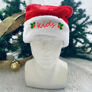 Detail of plush Christmas hat for kids with red embroidery and holly berry pattern