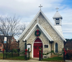 Close-up of 2.7m lush Christmas garland decorated on a rustic stone church entrance
