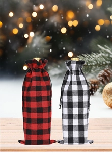 Detailed view of red and black buffalo plaid Christmas wine bottle gift bags with drawstrings