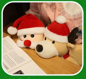 Detail of plush Santa and reindeer hand puppets with soft velvet hats for storytelling
