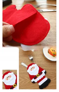 Close-up of handmade felt Santa Claus cutlery holder with detailed stitching on a wood table