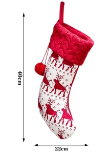 Close-up of red cable knit cuff and reindeer pattern on soft Christmas stocking