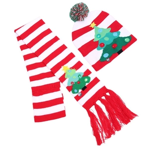 Knitted Christmas hat and scarf set with LED lights and colorful pompom on white background