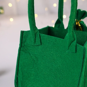 Close-up of vibrant green felt gift bag showing thick fiber texture and stitching