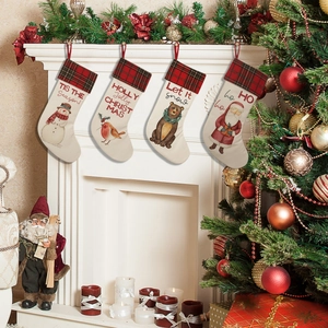 Close-up of four hanging Christmas stockings with festive snowman and Santa patterns