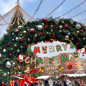 Detail view of red and green Merry Christmas banner with reindeer and santa decorations