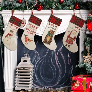 Detailed view of four rustic Christmas stockings hanging on a white decorated fireplace