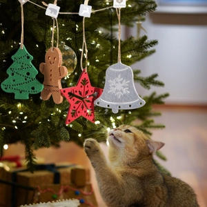 Felt Christmas ornaments set with gingerbread man and tree being touched by a ginger cat