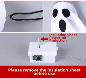 Detail of Halloween ghost hanging light showing hook, smiling face, and battery power switch