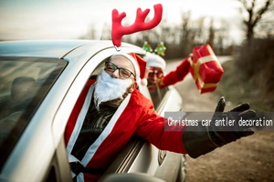 Close-up of plush red Christmas car antlers with secure window clips in outdoor setting