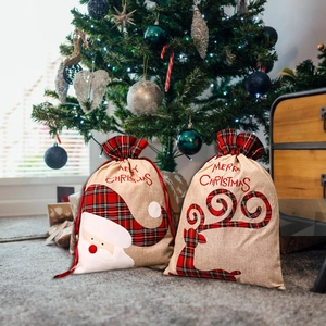 Large burlap Christmas gift bags with Santa and Reindeer designs and plaid drawstrings